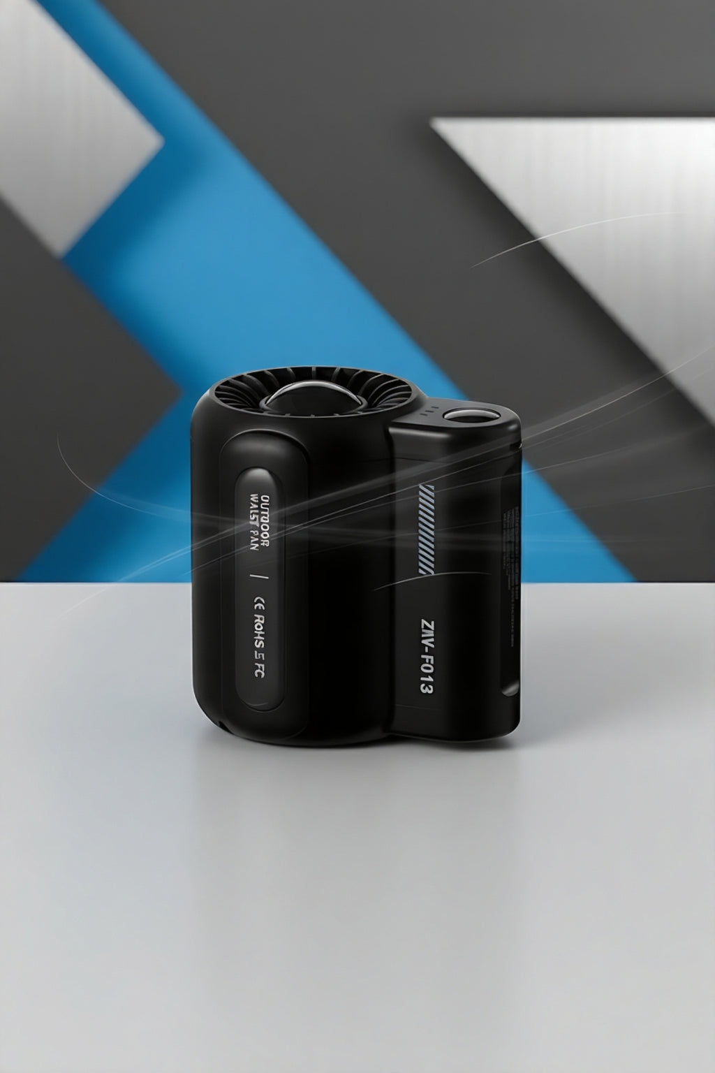 Black compact outdoor air purifier with fan on white surface and geometric blue and gray background