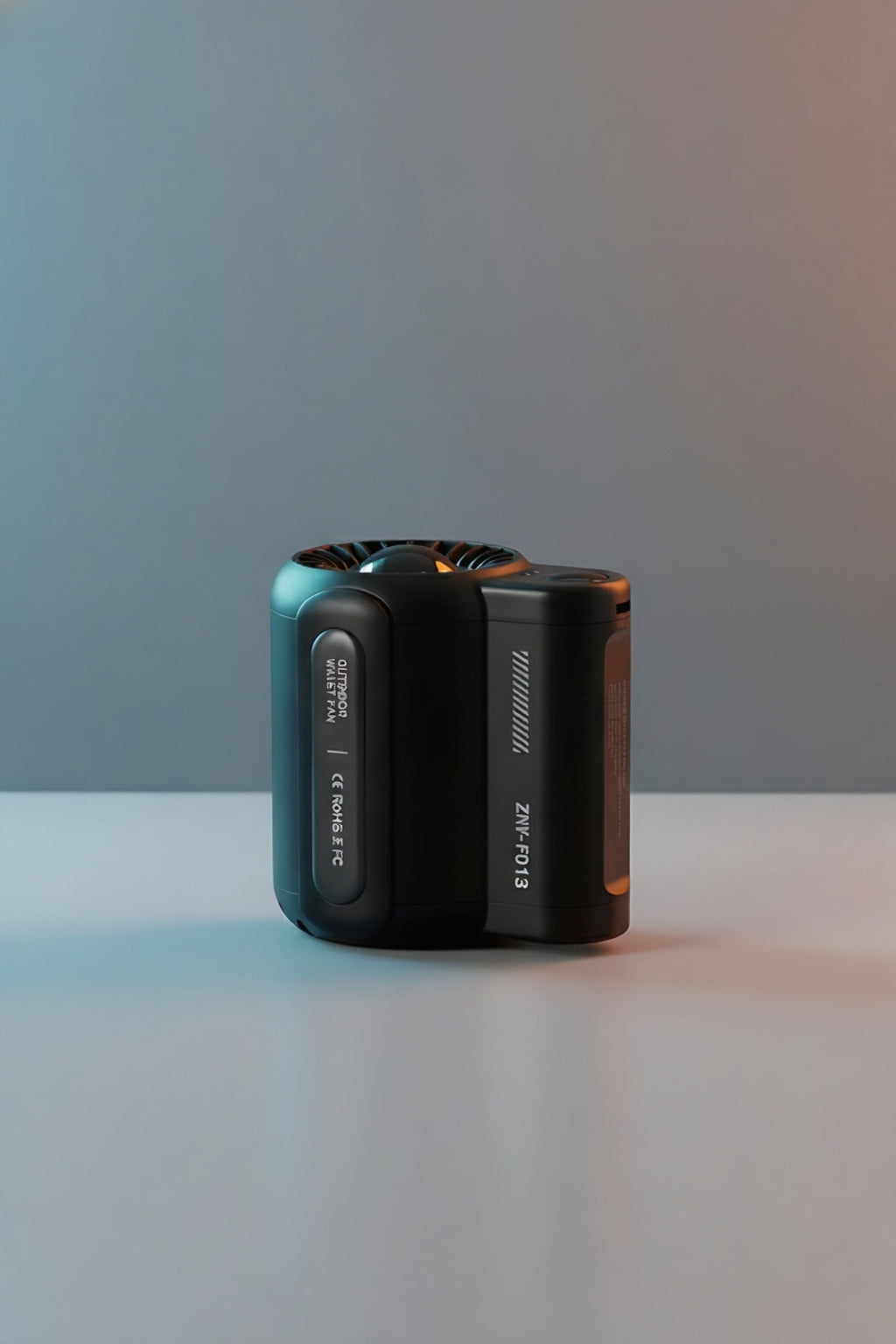 Compact black outdoor wireless fan with modern design on smooth surface